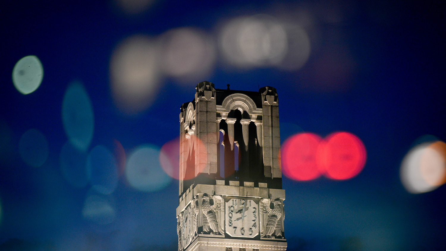 The NC State Belltower, superimposed with a bokeh light effect