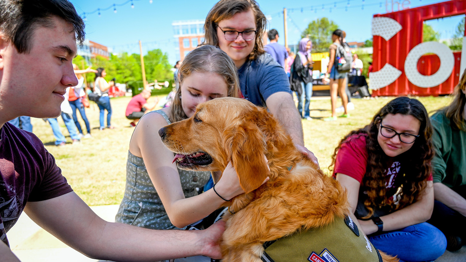 Students, faculty and staff enjoy a spring day by participating in a Pause for Tiny Hooves event at the Corner on Centennial campus. Therapy miniature horses from Stampede of Love, as well as therapy dogs, provide a wellness break from the end of semester rush. Photo by Becky Kirkland.