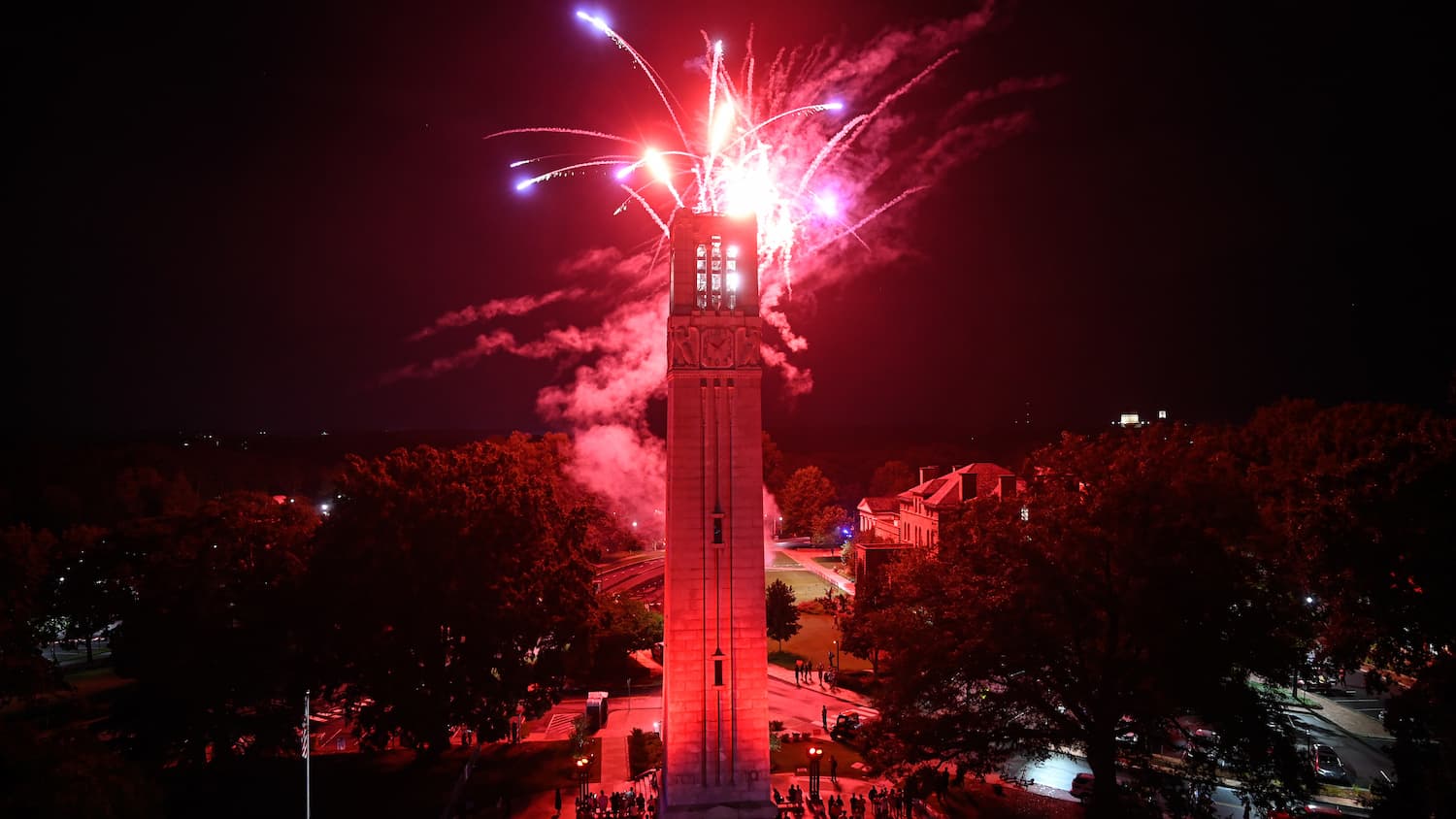 Fireworks explode over the NC State Belltower.